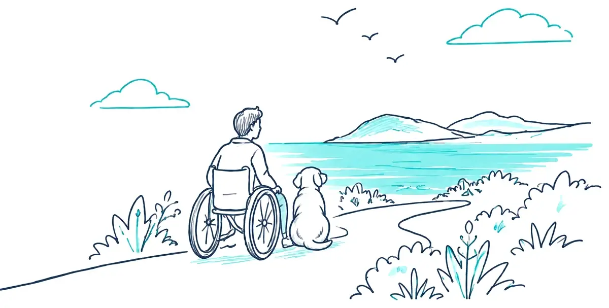 A man in a wheelchair and his dog looking out over the sea from a coastal path